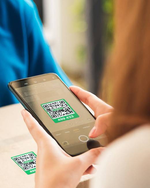 A phone camera scanning the green QR label on a shipping carton